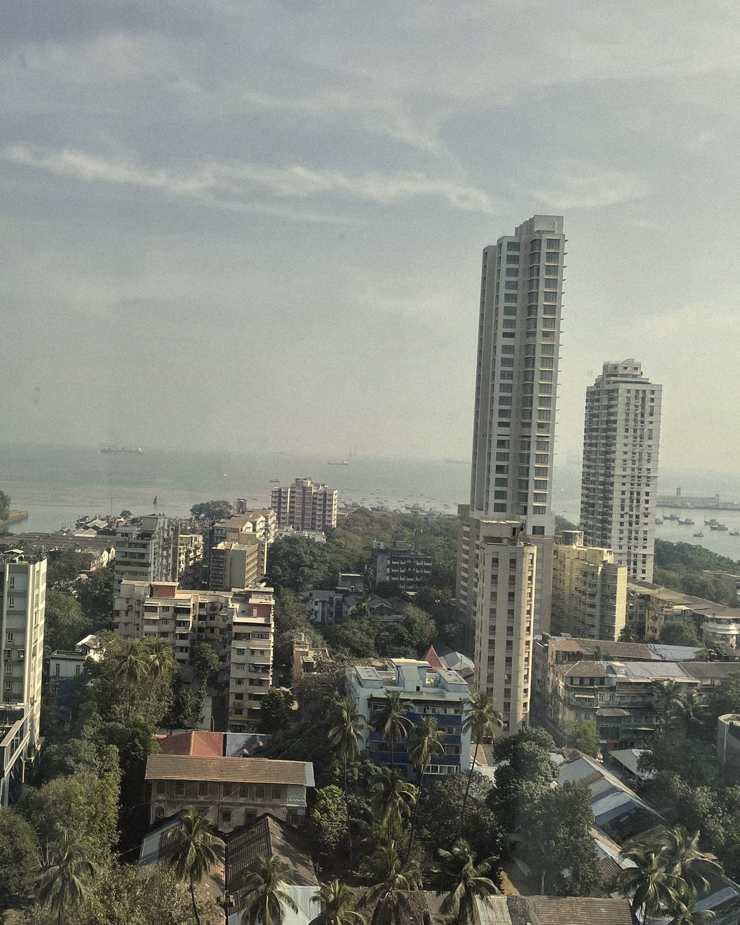 High-rise towers and green rooftops of Andheri West stretching to the sea