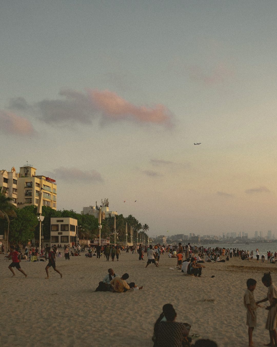Juhu beach in the evening with families walking on the sand