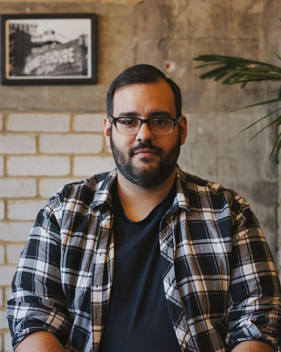 Man in a checked shirt sitting in a café